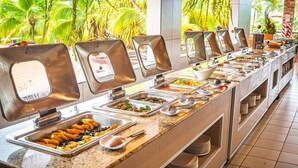 A buffet with various food stations, including trays of appetizers and salads, arranged along a long counter. - Best Western Jaco Beach All Inclusive Resort (Jacó)