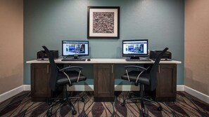 A conference room with two desks, each with a computer and a printer, and two office chairs. - Spark by Hilton Fort Myers (Fort Myers)