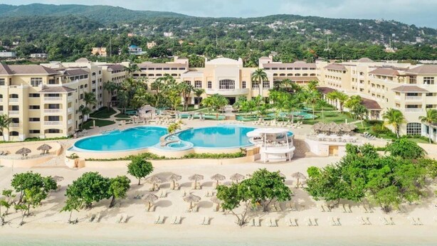 A resort with multiple swimming pools, a beach area, and a mountainous backdrop. - Iberostar Waves Rose Hall Beach All Inclusive (Montego Bay)