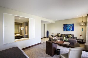 A modern living room with a sofa, coffee table, and a large painting on the wall. - The Tower Plaza Hotel Dubai (Dubai)