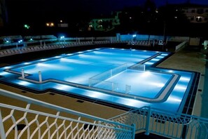 A swimming pool with a white fence and a metal railing. - Tropical Sol (Albufeira)