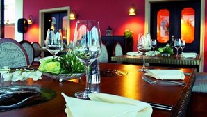 A restaurant interior with tables set for dining, featuring clear glassware and a floral centerpiece. - TAN Resorts Marina Cap Cana (Punta Cana)