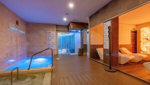 A spa area with a hot tub, wooden flooring, and lounge chairs. - TAN Resorts Marina Cap Cana (Punta Cana)