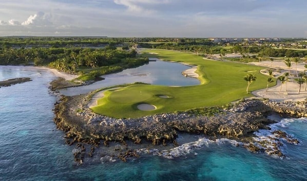 Ein Küsten-Golfplatz mit Wasserschutzgraben, Bunkersand und freiem Blick auf den Ozean.