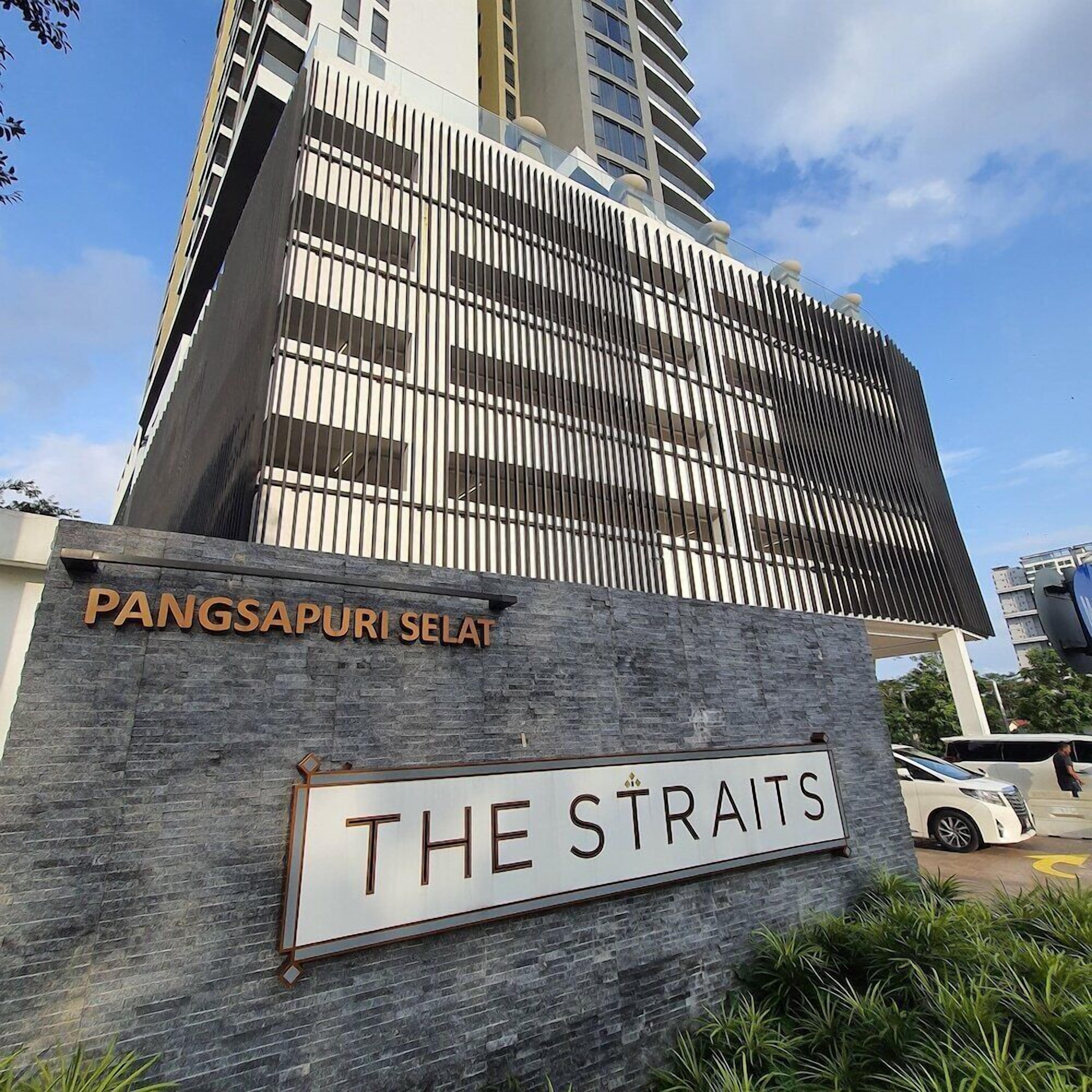A building with a sign reading 'PANGSAPURI SELAT' and 'THE STRAITS'.