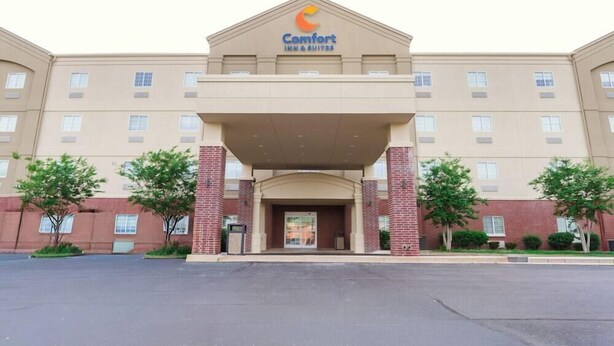 A Comfort Inn & Suites hotel with a symmetrical facade, a central entrance, and a brick base.