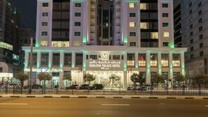 A hotel with a prominent archway and illuminated signage. - Khalidia Palace Hotel Dubai (Dubai)