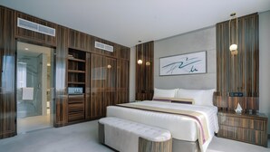 A bedroom with a large bed, a bench, a wardrobe, and a bedside table. - Khalidia Palace Hotel Dubai (Dubai)