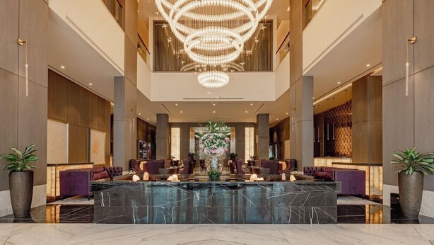A spacious lobby with a large marble reception desk, elegant seating, and a grand chandelier. - Khalidia Palace Hotel Dubai (Dubai)