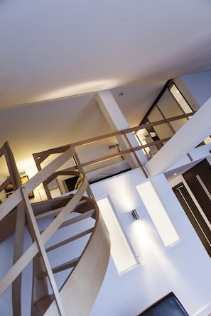 A multi-level interior with a spiral staircase, a flat ceiling, and a modern design. - Hotel Progress (Brussels)