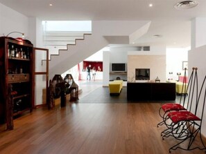 A spacious living area with a staircase, a sofa, and a television. - Vila Valverde Design and Country Hotel (Lagos)