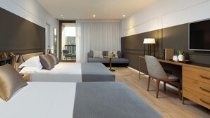 A modern hotel room with two beds, a sofa, a desk, and a TV. - King Solomon (Jerusalem)