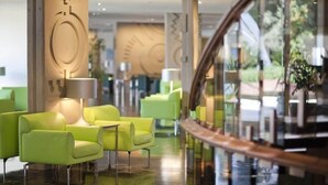 A hotel lobby with green seating, a glass railing, and a modern design. - Croatia Hotel (Konavle)