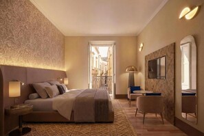 A hotel room with a large bed, a TV, a desk, and a view of the street.