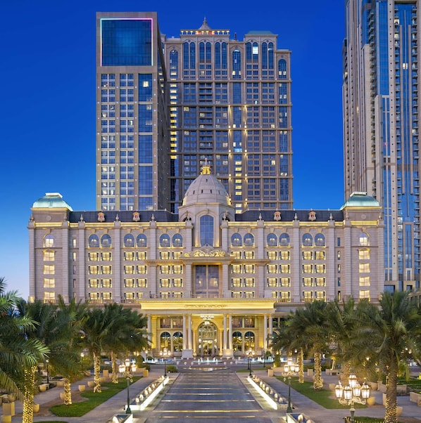 A grand hotel with a central dome, multiple floors, and a well-lit facade. - Al Habtoor Palace (Dubai)