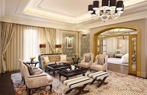 A luxurious hotel room with a grand chandelier, plush seating, and a large mirror reflecting the room's elegance. - Al Habtoor Palace (Dubai)