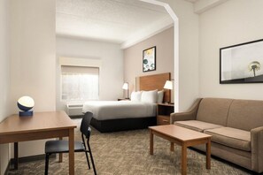 A hotel room with a bed, a sofa, a desk, and a chair. - Best Western Windsor Inn & Suites (Danville)