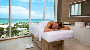 A room with a large window, a bed, a wooden cabinet, and a mirror. - Hilton At Resorts World Bimini (Alice Town)