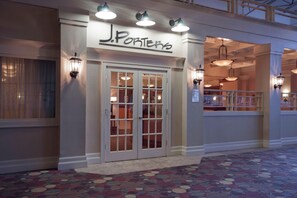 A hotel entrance with a sign reading 'J. Porters' and a set of double doors with glass panels. - Wyndham Flint Mi/grand Blanc/bishop Airport/conference Ctr (Flint)