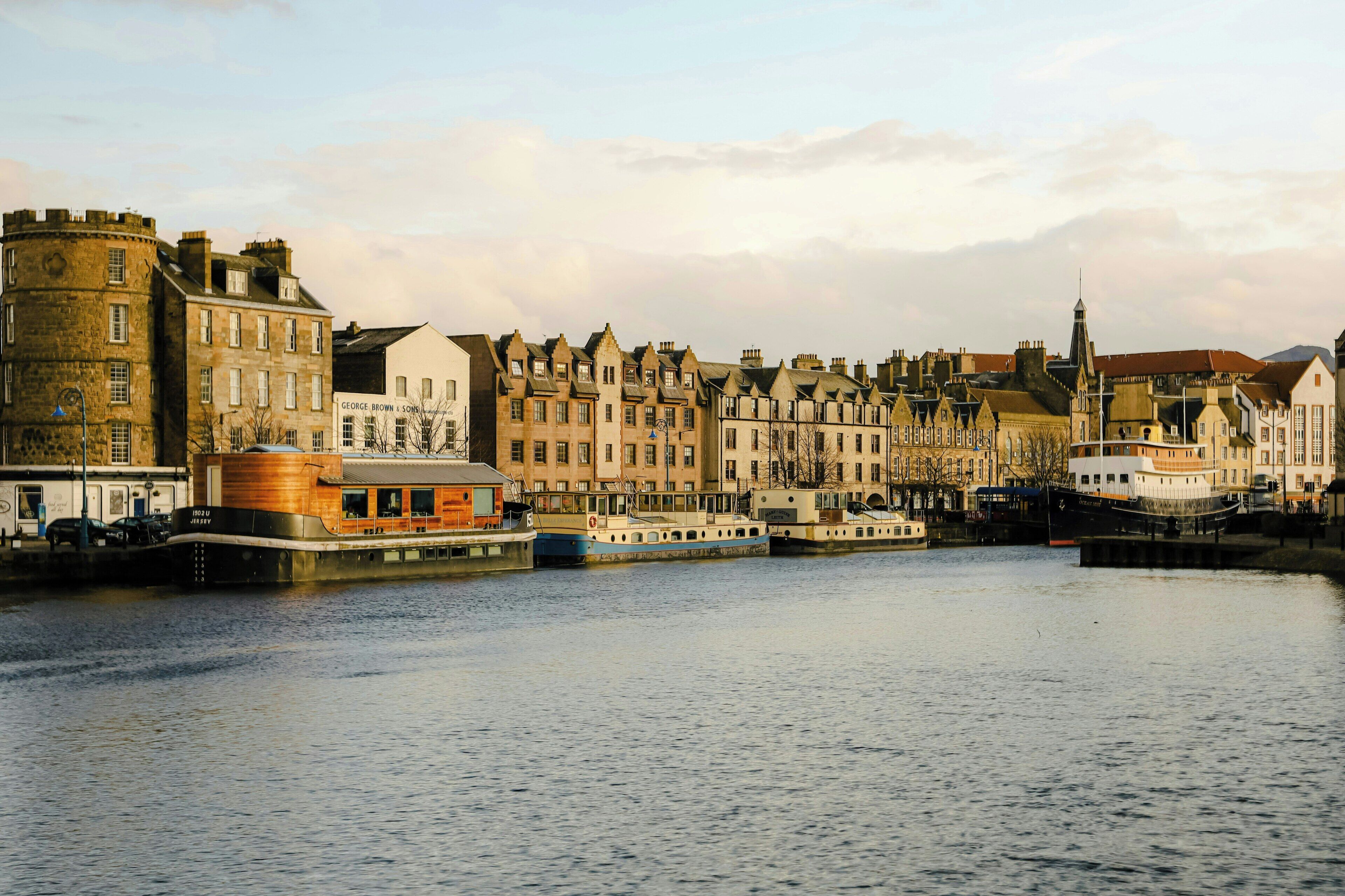 A waterfront cityscape with historic buildings and a river.