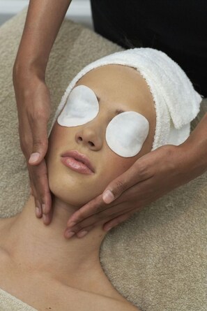 A person receiving a facial treatment with a towel wrapped around their head. - Dock House Boutique Hotel (Cape Town)