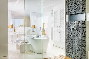 A modern bathroom with a freestanding bathtub, a glass shower enclosure, and a white vanity with a mirror. - Minos Imperial Luxury Beach Resort and Spa Milatos (Agios Nikolaos)