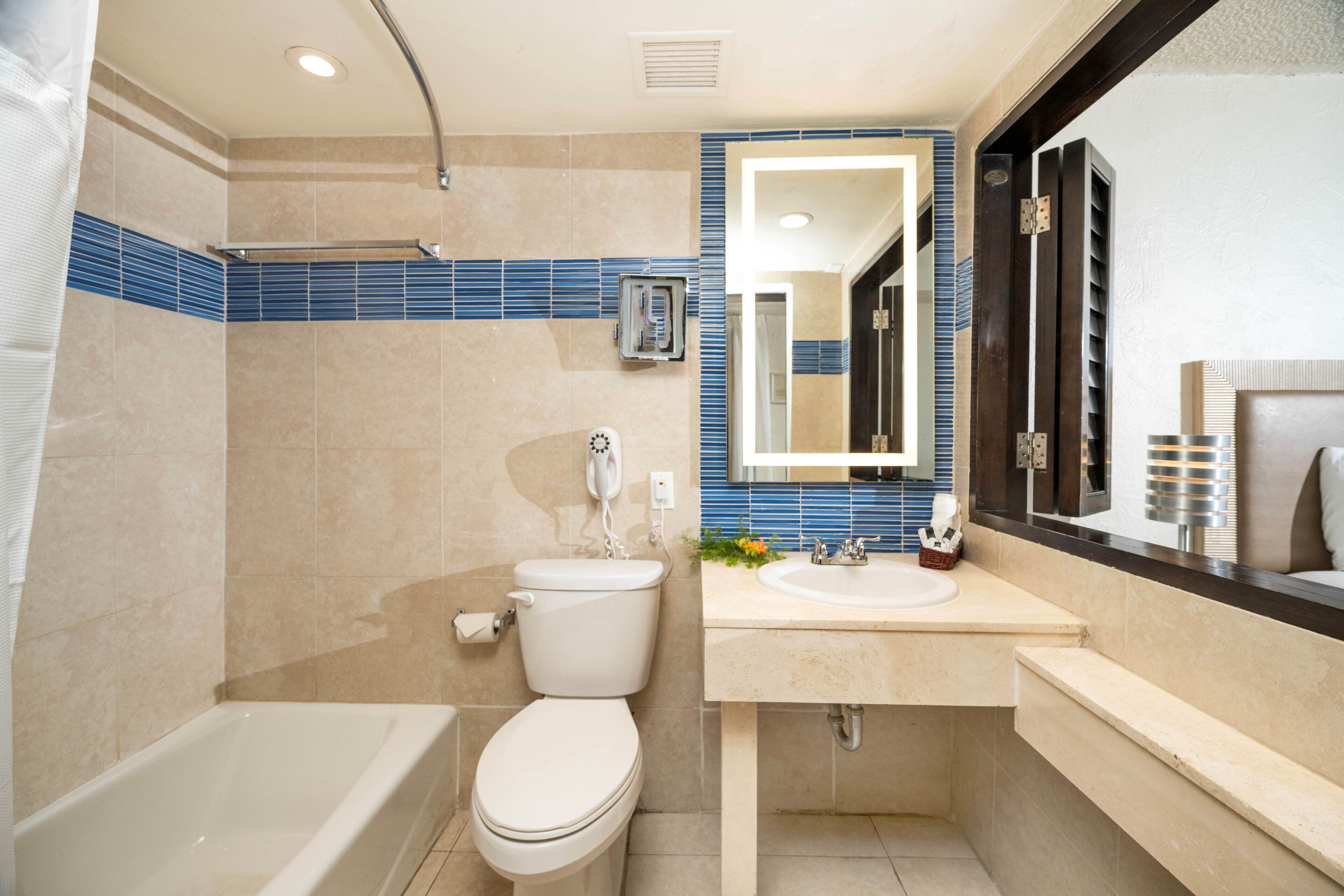 A modern bathroom with a bathtub, toilet, and sink.