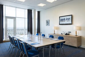 A conference room with a long table, chairs, a desk with a telephone, and a 'Park Inn' sign. - Park INN BY Radisson Palace Southend ON SEA (Southend-on-Sea)