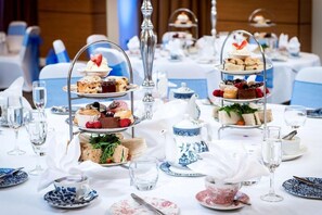 A table set for a tea service with tiered dessert stands, teapots, and glassware. - Park INN BY Radisson Palace Southend ON SEA (Southend-on-Sea)