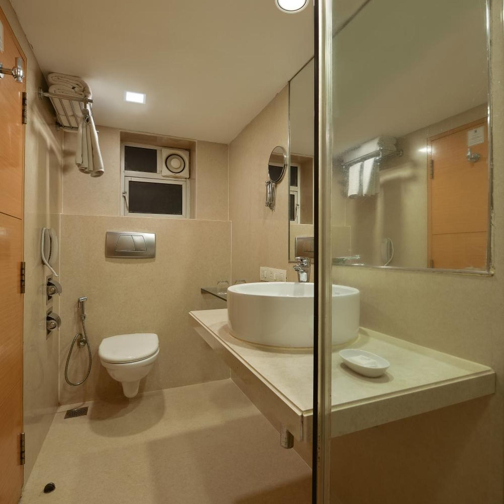 A modern bathroom with a toilet, a sink, and a shower area.