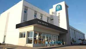 A modern hotel building with a prominent sign for 'MIA HOTELS' and a logo. - MIA Urban Agadir (Agadir)