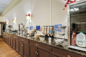 A breakfast bar with various food items and drink dispensers. - Best Western Watertown Fort Drum (Watertown)