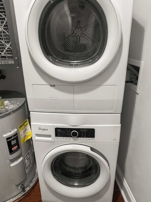 A stacked washer and dryer unit with a control panel and a water tank. - Sleek Studio near The Fillmore | NoLibs | Sleeps 2 (Philadelphia)