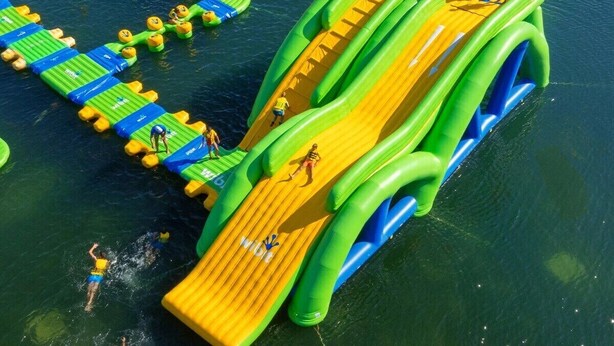 An inflatable water park with slides and platforms.