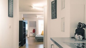 A modern kitchen with a coffee machine, a refrigerator, and a glass counter. - LU Mercury lll - Old Town HITrental Apartment by Interhome (Lucerne)
