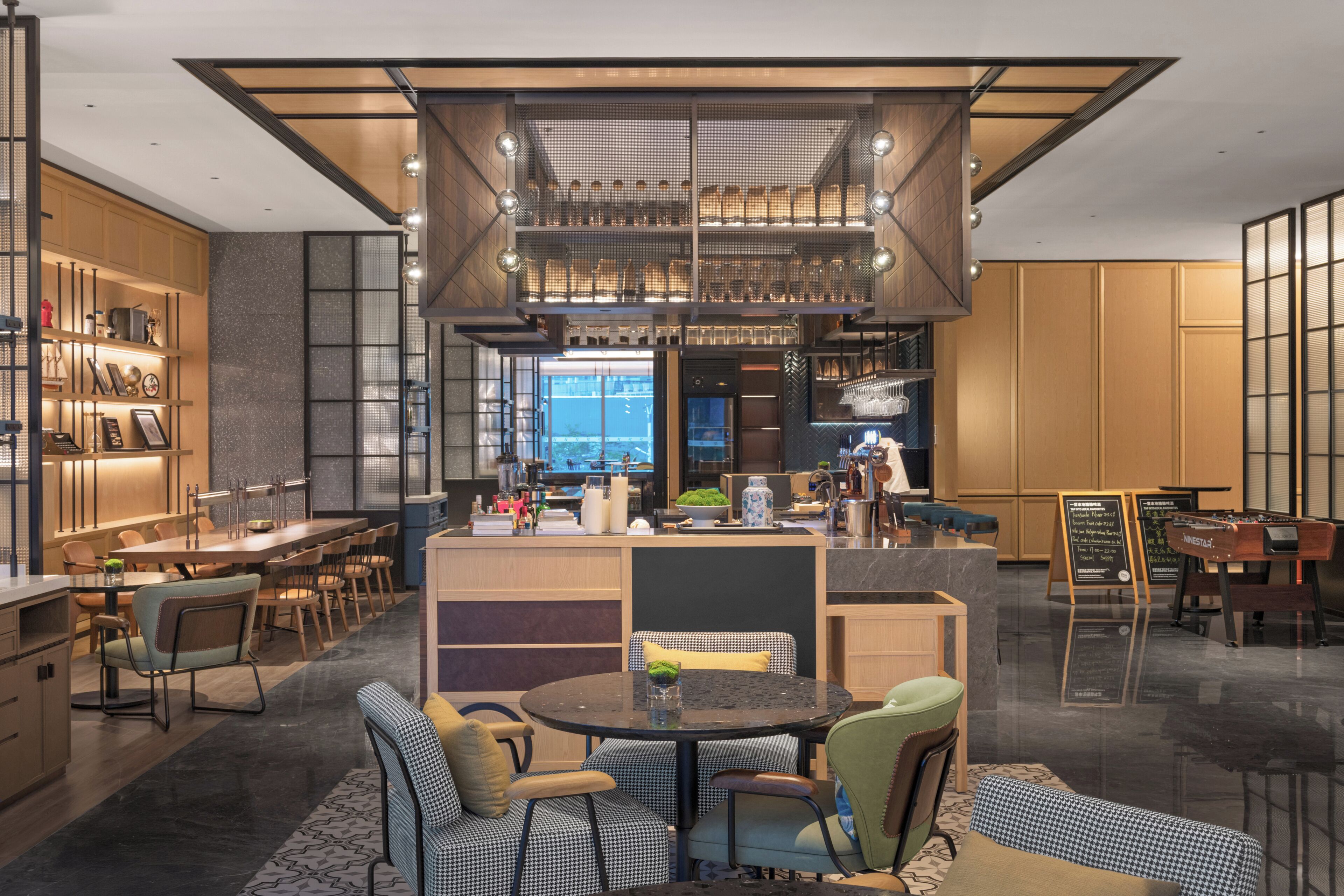 A modern interior with a dining area, kitchen, and bar.