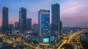 A modern cityscape with prominent skyscrapers, including a building with 'FOUR POINTS' signage, surrounded by busy roads and urban infrastructure. - Four Points By Sheraton Guangzhou Changlong Wanbo Business District (Guangzhou)