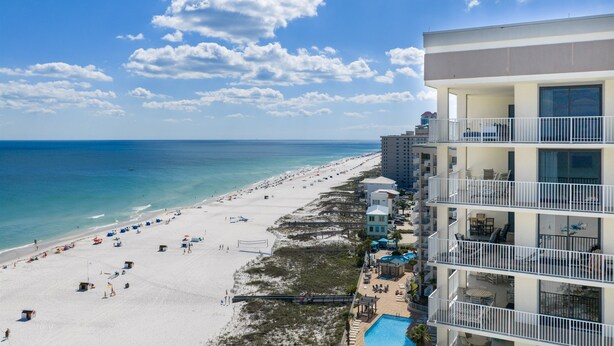 A beachfront hotel with multiple balconies, a pool, and beach access. - Windward Pointe 3 Bed 2 Bath - Sleeps 10.  Free Daily Activities! (Orange Beach)