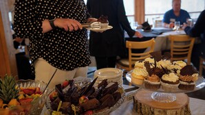 A buffet with various desserts and fruits.