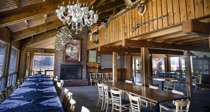 One Room Cabin with a double bed and small table with two chairs
