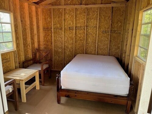 One Room Cabin with a double bed and small table with two chairs