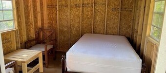 One Room Cabin with a double bed and small table with two chairs