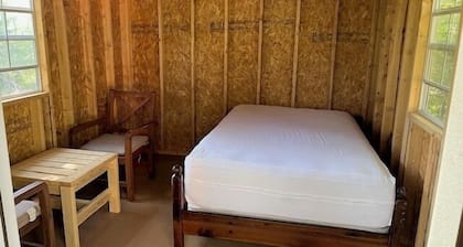 One Room Cabin with a double bed and small table with two chairs