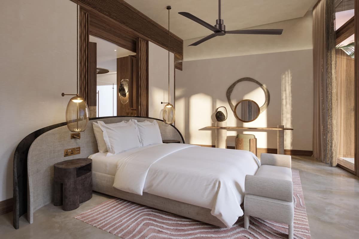 A modern bedroom with a bed, bedside tables, a ceiling fan, and a large mirror.