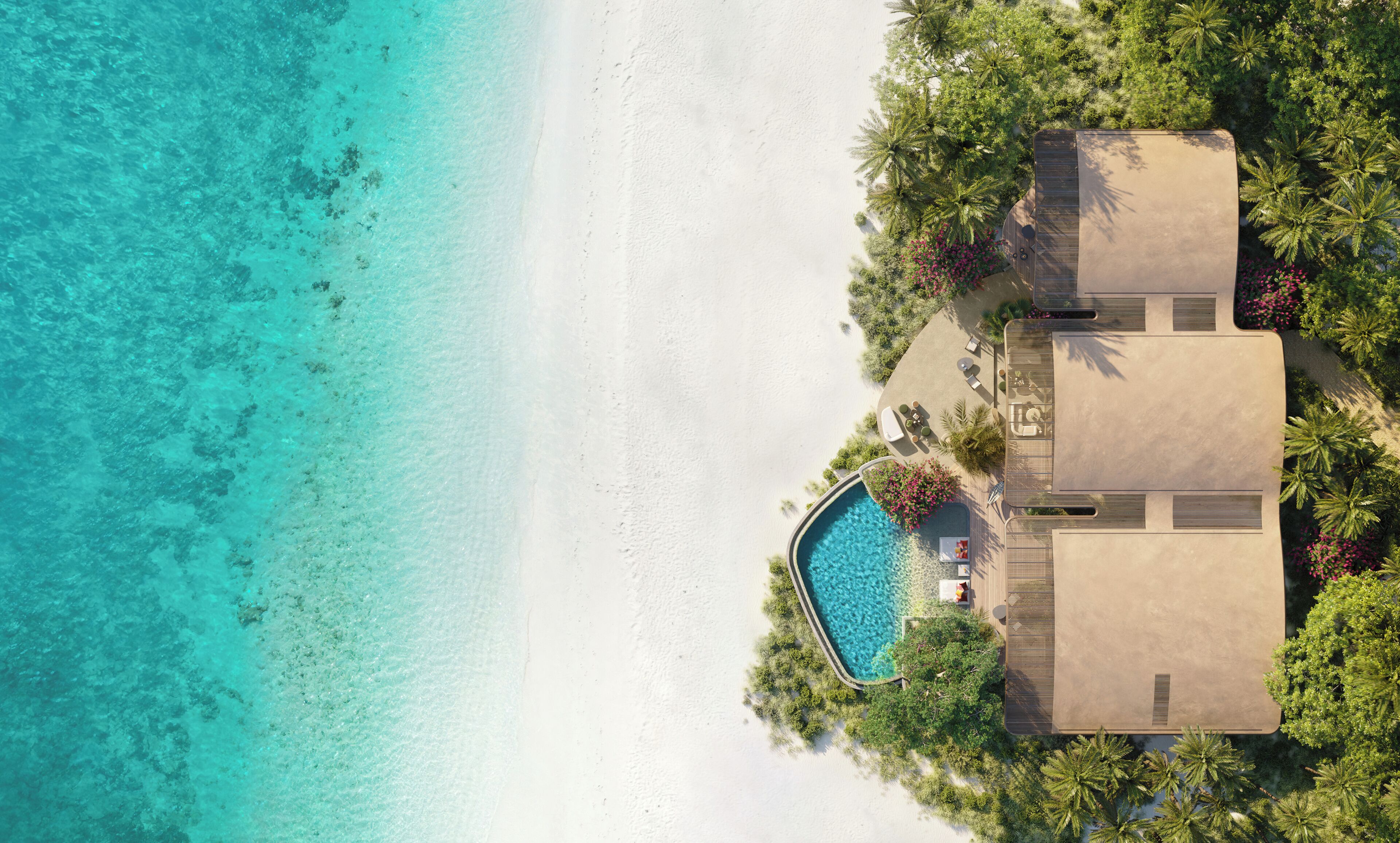 A resort with a swimming pool, a beach, and lush greenery.