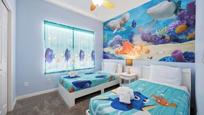 A children's room with two beds, a ceiling fan, a window with curtains, and a mural of an underwater scene. - Blissful Disney Escape 2BR Minutes to Magic (Kissimmee)