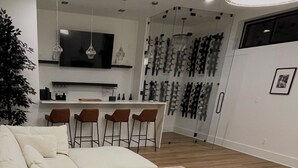 A modern living room with a sofa, a coffee table, and a dining area with chairs.