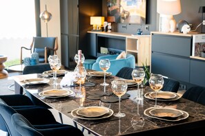 A dining area with a marble table set for a meal, including plates, glasses, and cutlery. - La Badoumba · Heated Pool & Jacuzzi (Saleilles)