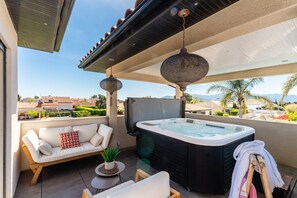 A rooftop terrace with a hot tub, outdoor seating, and a view of the surrounding landscape. - La Badoumba · Heated Pool & Jacuzzi (Saleilles)