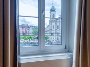 A window with a view of a building with a dome and a bridge. - Apartment  by Interhome (Lucerne)